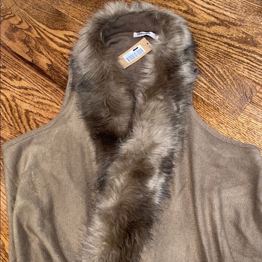 Wrap with faux fur trim and fringe detail at hem